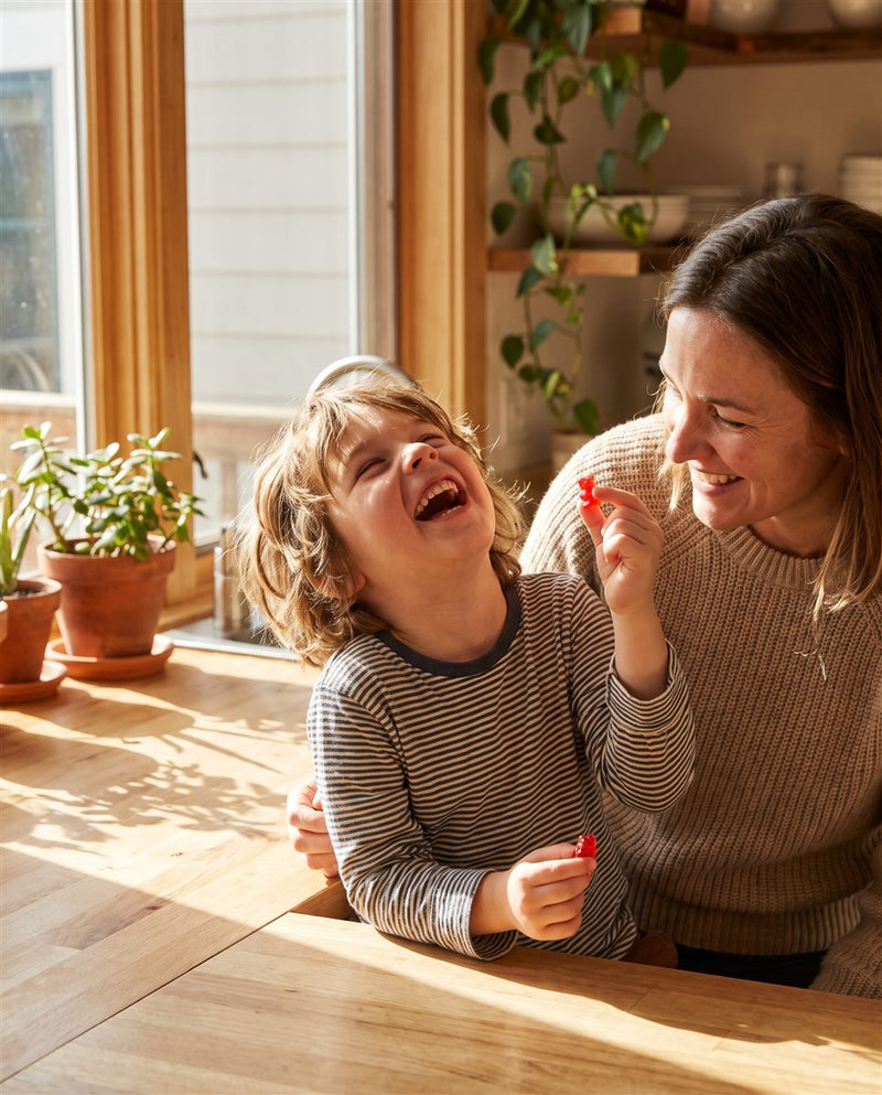 Week 4: laughing and holding up a gummy