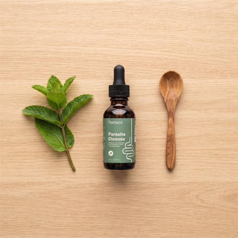 Nurtura Parasite Cleanse Drops with mint and a wooden spoon