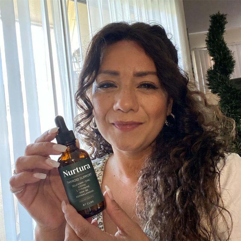 Nurtura customer holding her Thyroid Support Drops